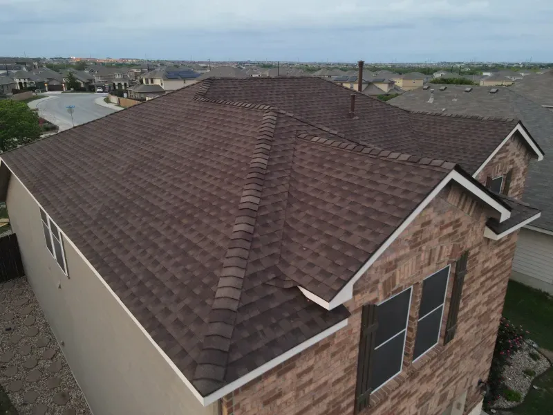 An aerial view of a house with a brown roof