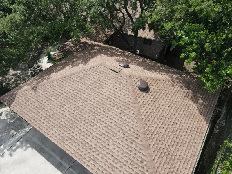 An aerial view of a roof with trees in the background.