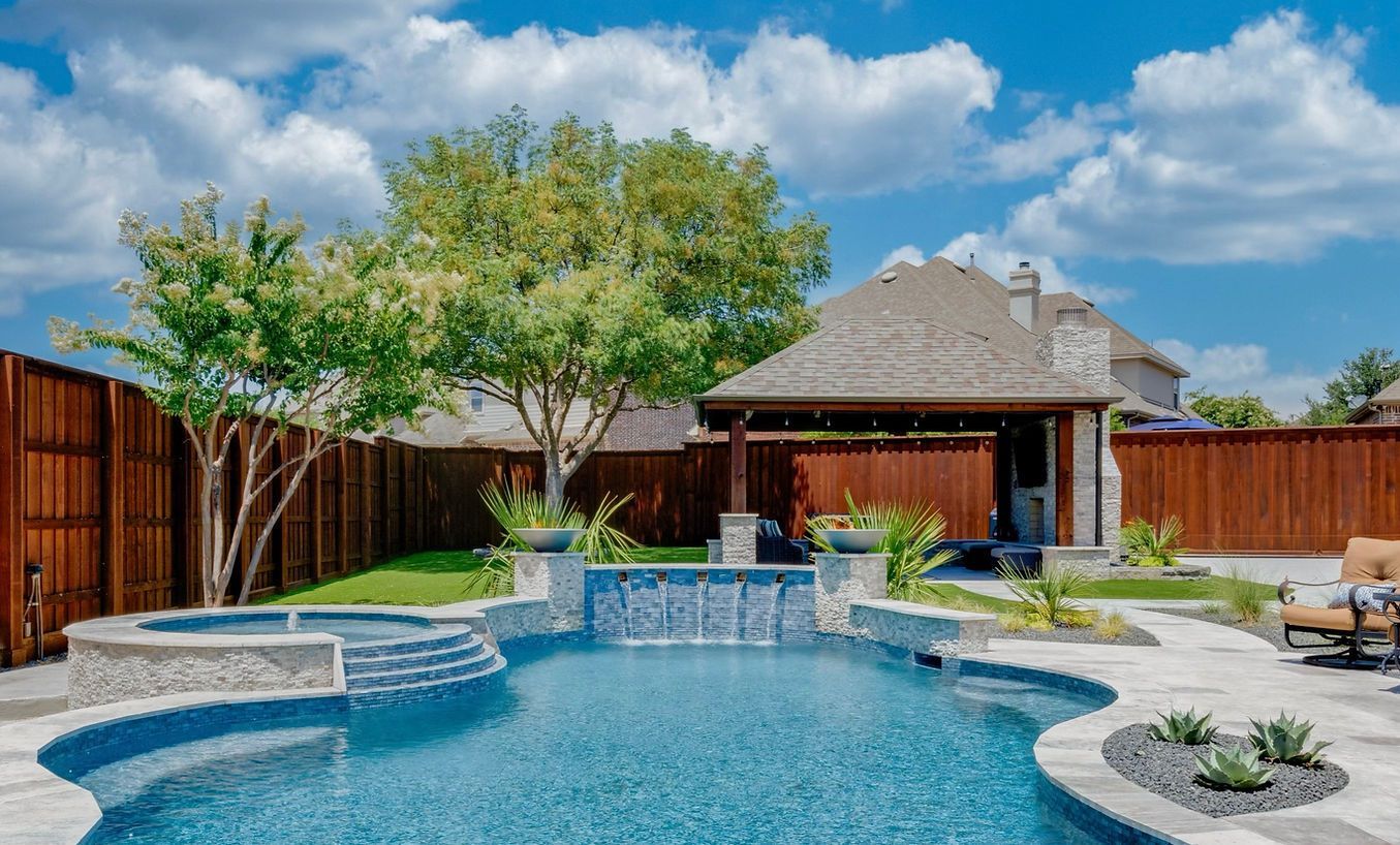 There is a large swimming pool in the backyard of a house.