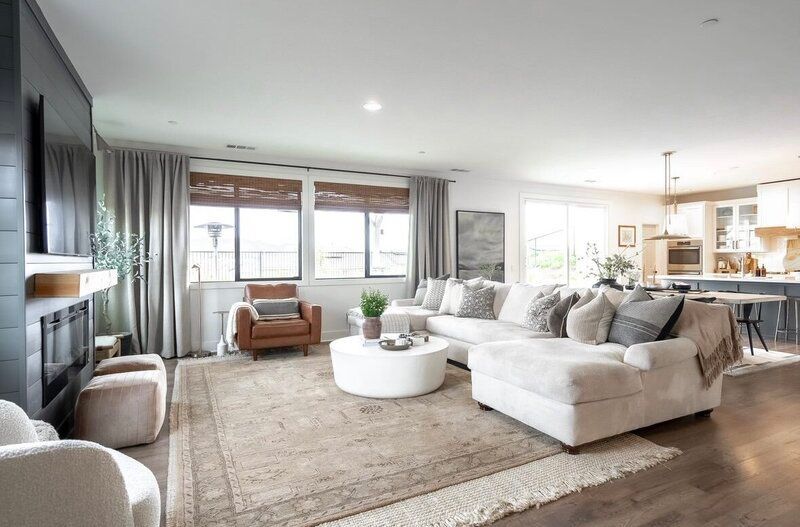 Living room with a sectional sofa, rug, and dark accent wall.