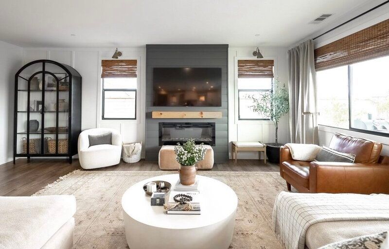 Living room with fireplace, leather chair, and neutral tones.