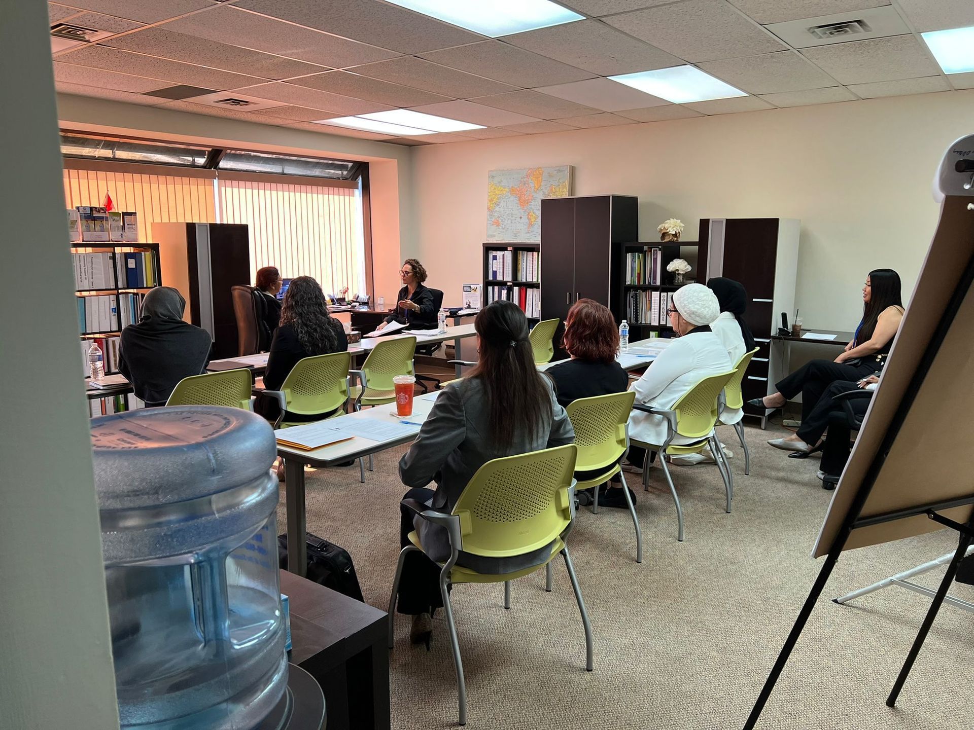 A group of people are sitting at tables in a room.