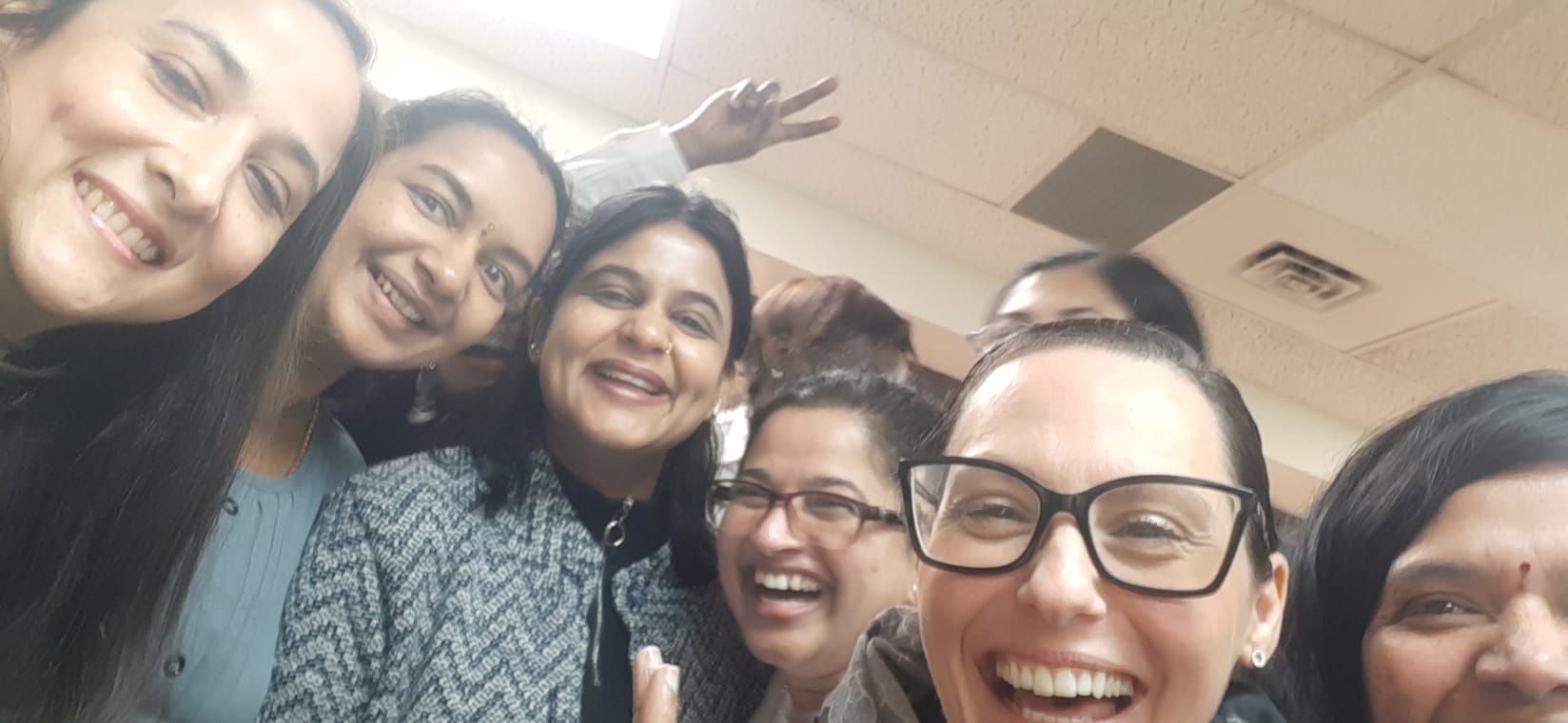 A group of women are posing for a picture together and smiling.
