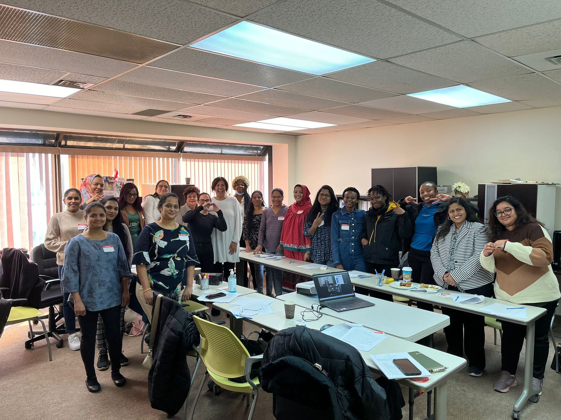 A group of people are posing for a picture in a room.