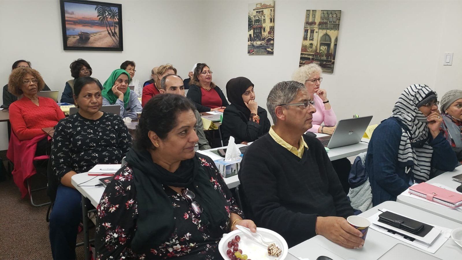A group of people are sitting at tables in a room