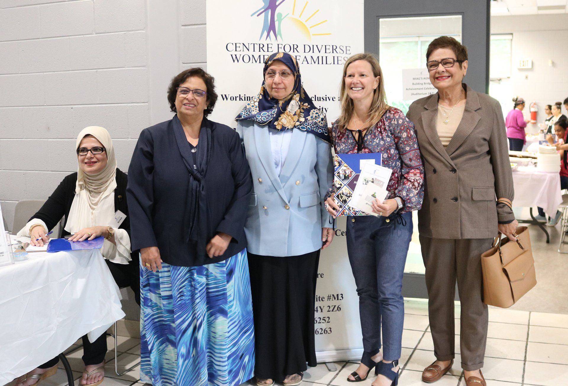 A group of women are posing for a picture together.
