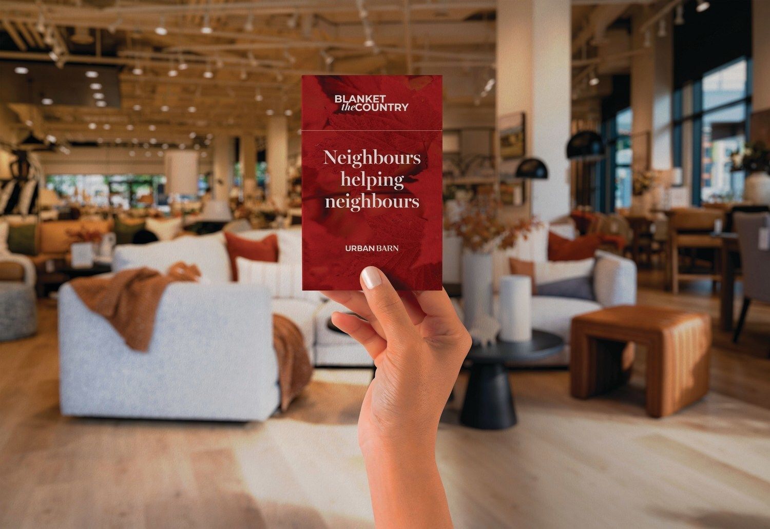 Hand holding a card in a furniture store. The card reads 