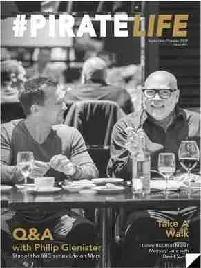 Two men are sitting at a table in a restaurant drinking wine.