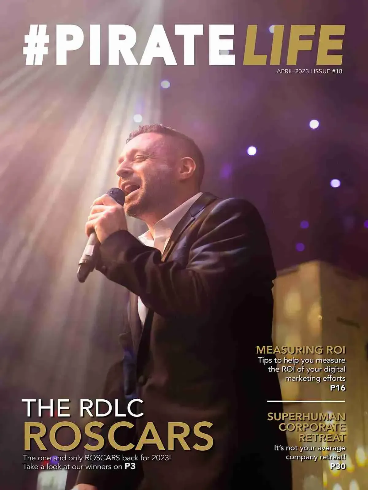 A man in a suit is singing into a microphone on the cover of a magazine.