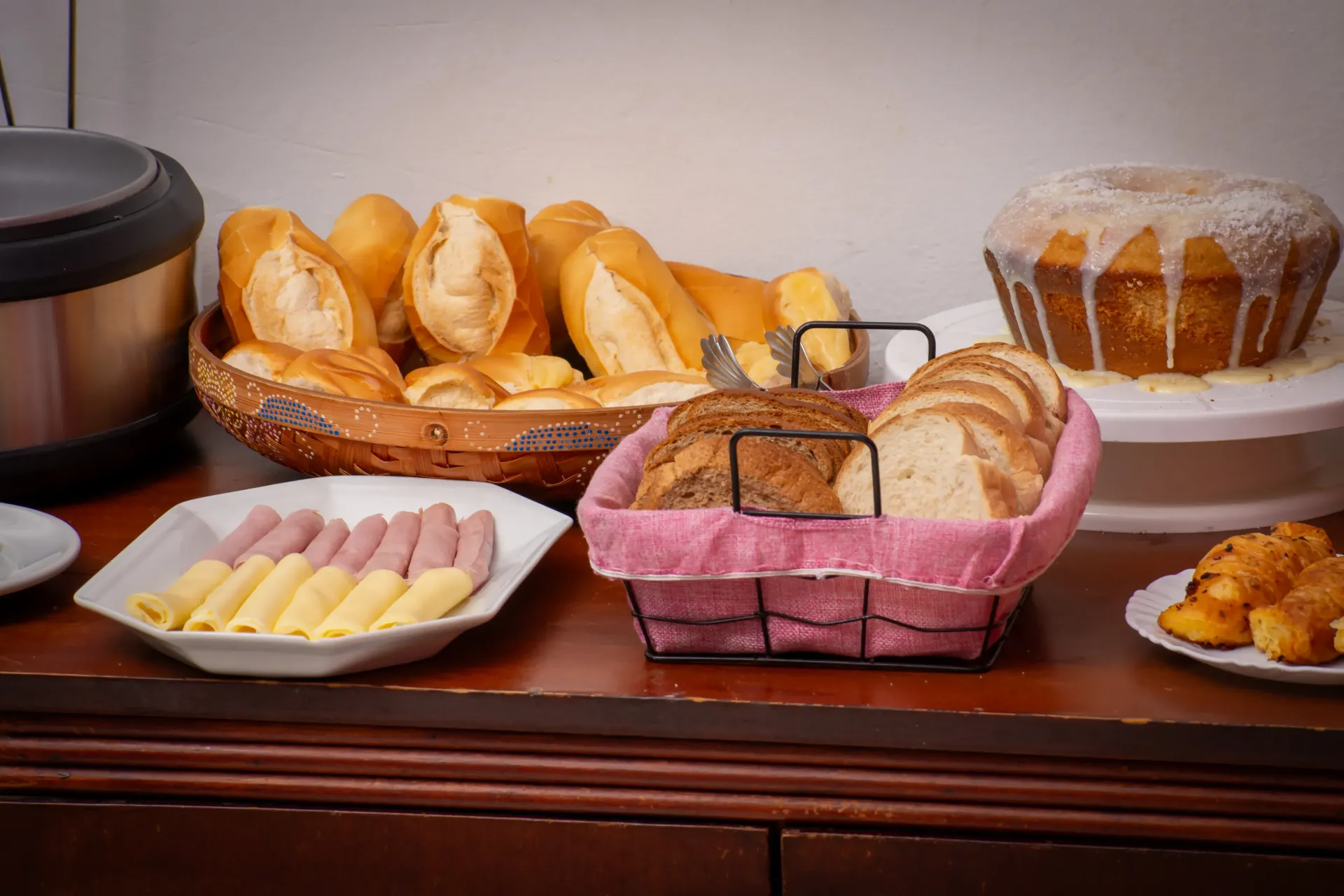 Uma mesa coberta com pratos de comida e bebidas. pousada-ocacocar