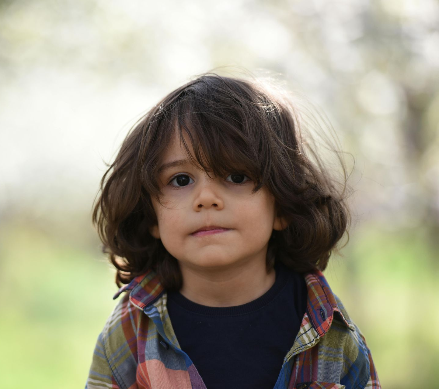 A person receiving a facial treatment. A esthetician applies a mask to the client's face.