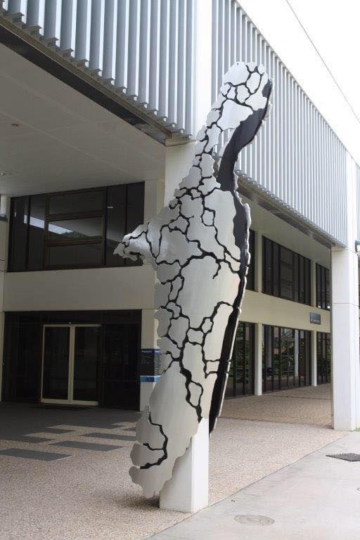 A black and white sculpture in front of a building