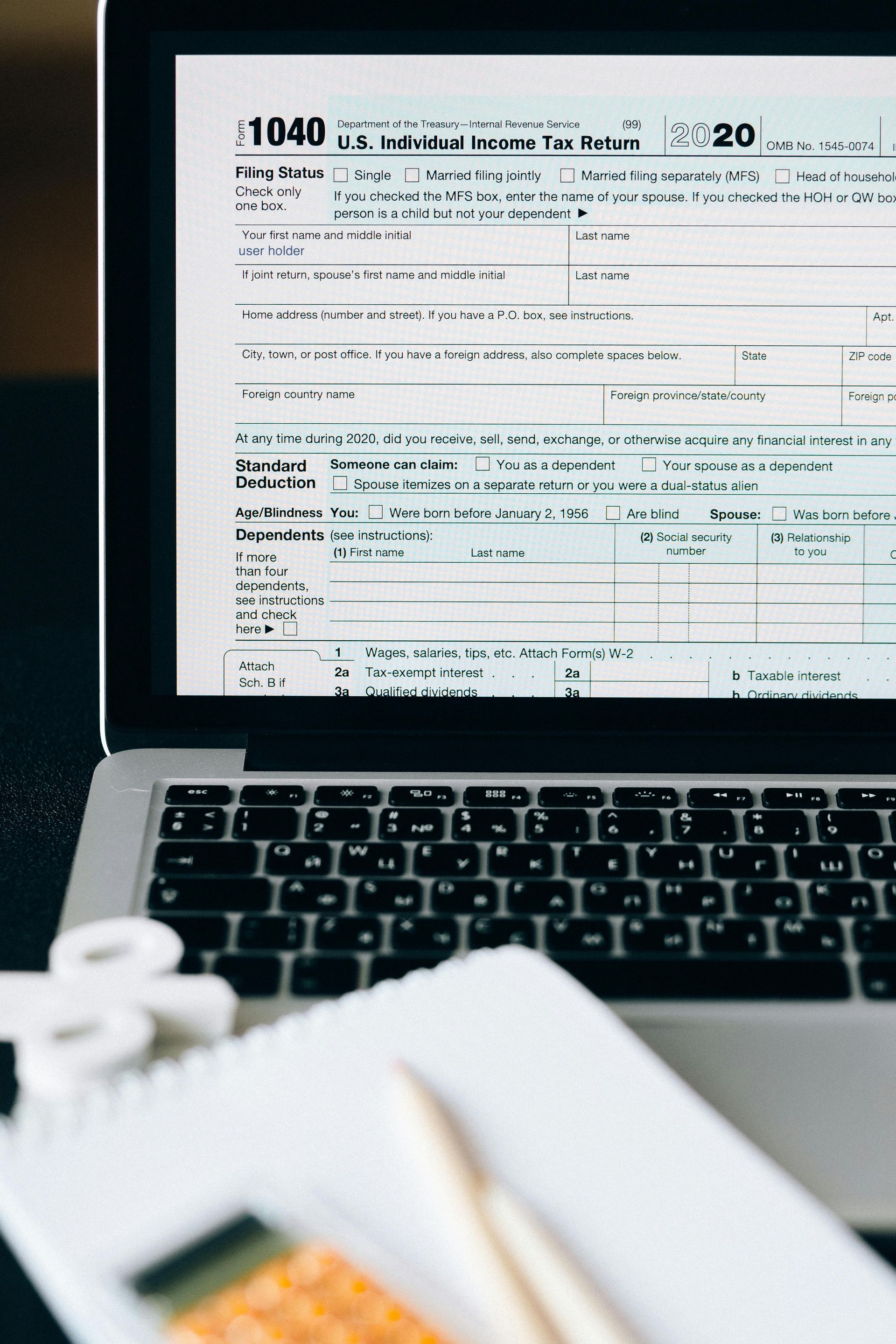 A close up of a laptop with a tax form on the screen