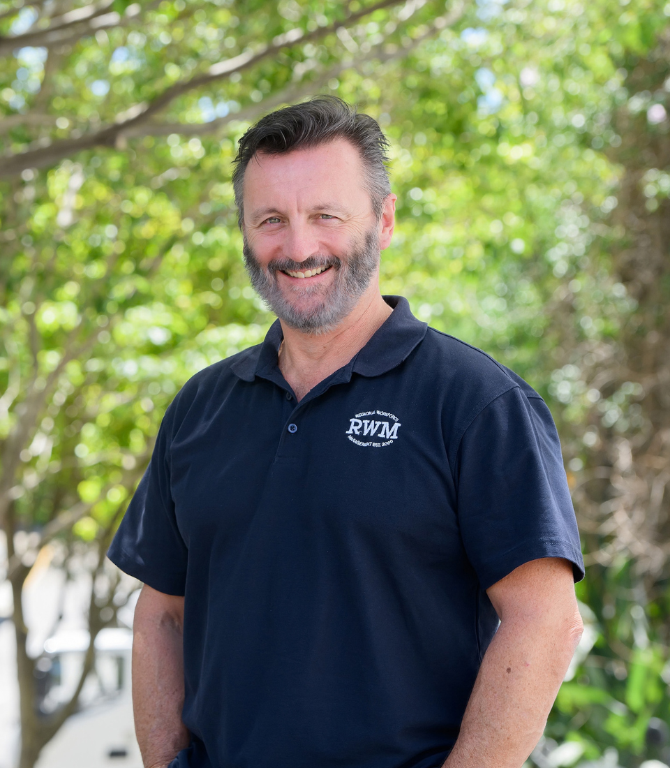 A man with glasses and a beard is wearing a black shirt