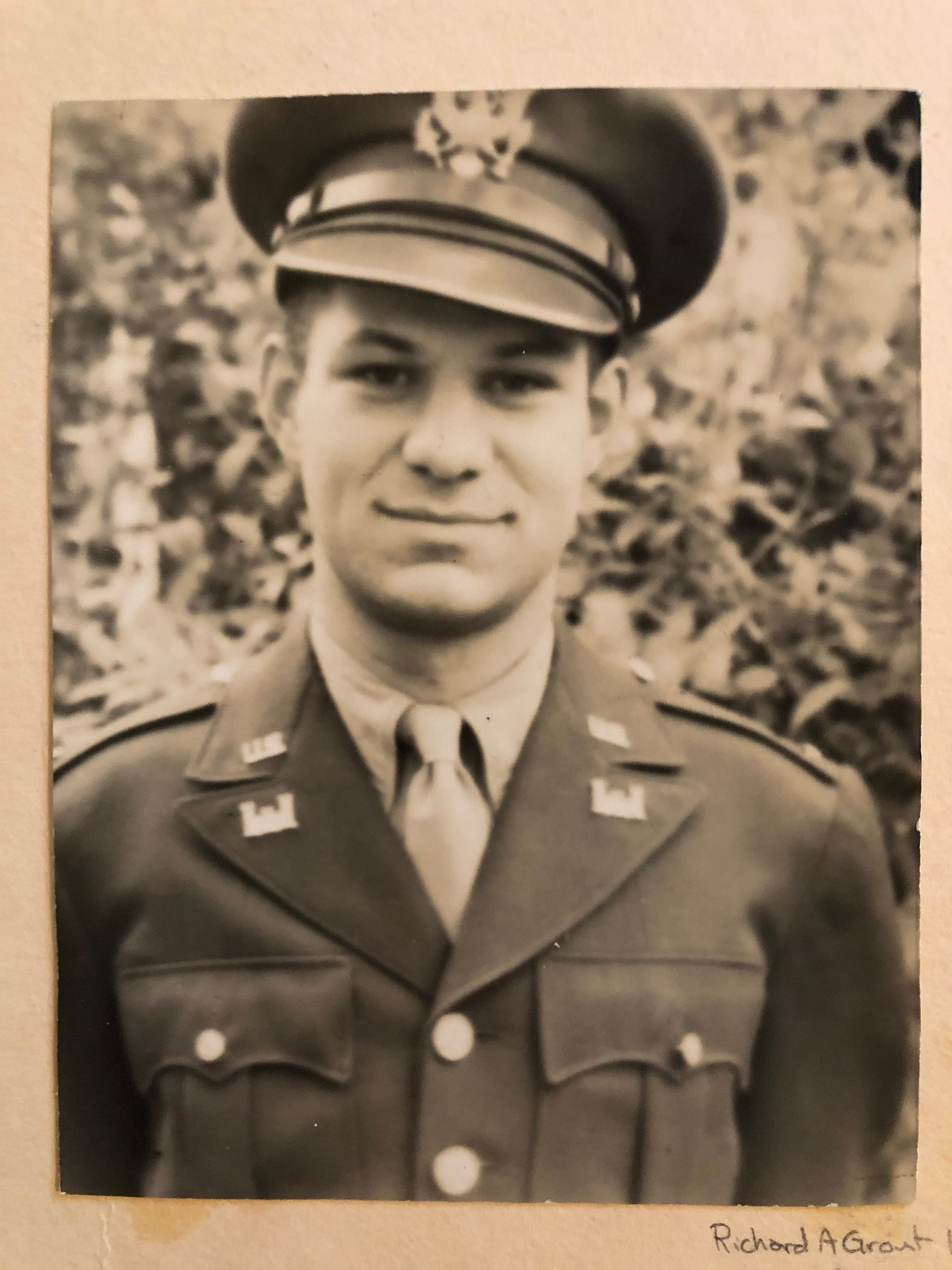 A black and white photo of a man in a military uniform