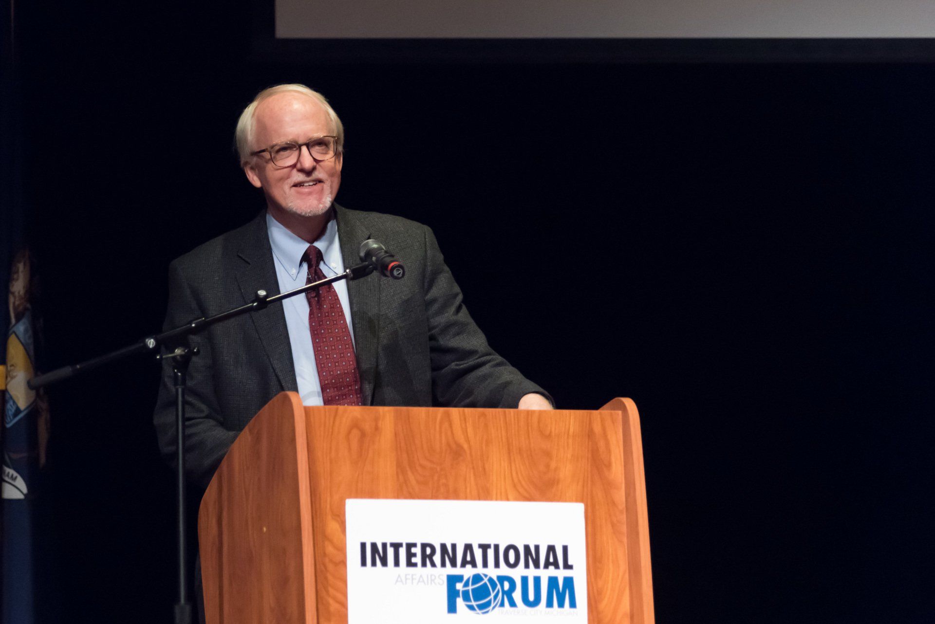 A man is giving a speech at the international forum