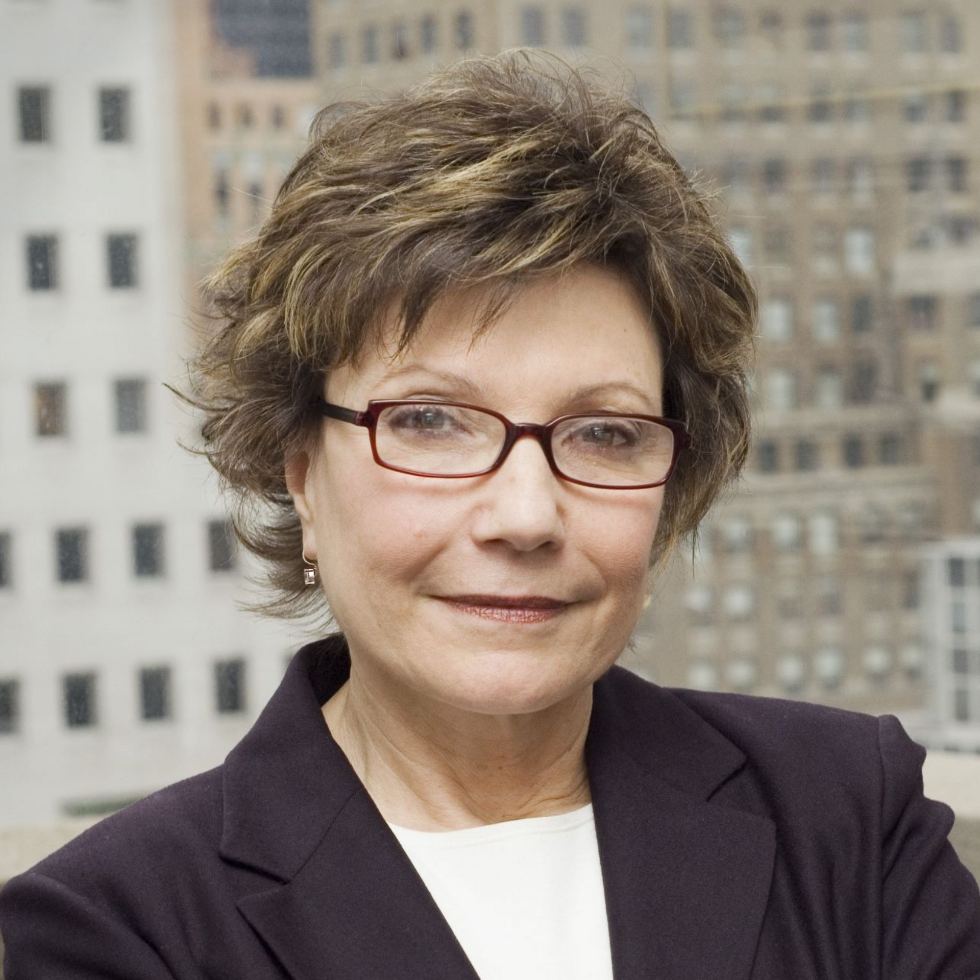 Man with gray beard looking to the side, wearing a dark shirt.