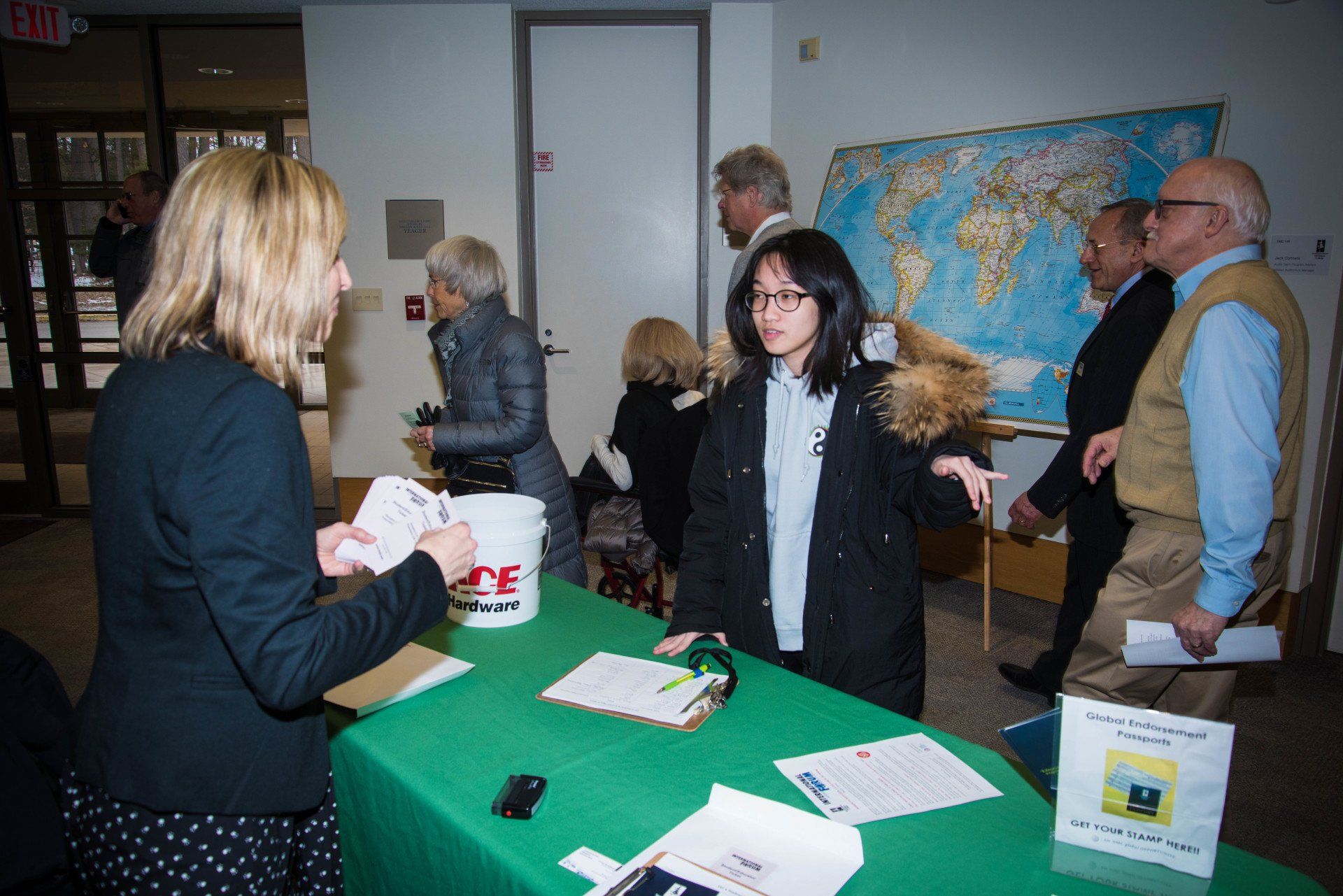 A group of people are standing around a table with a sign that says ' life ' on it
