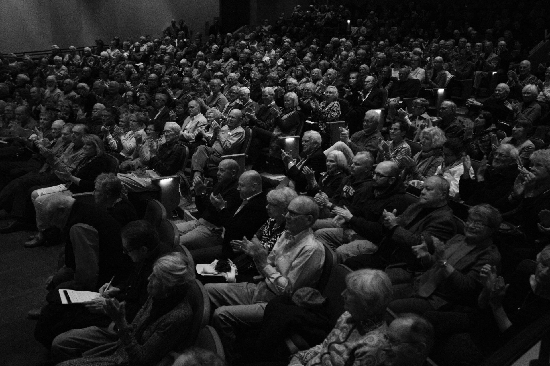 A large crowd of people are sitting in an auditorium