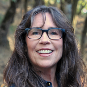 A man in a suit and tie is smiling for the camera.