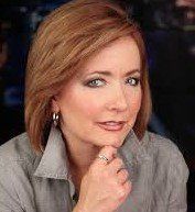 A close up of a woman 's face with her hand on her chin.