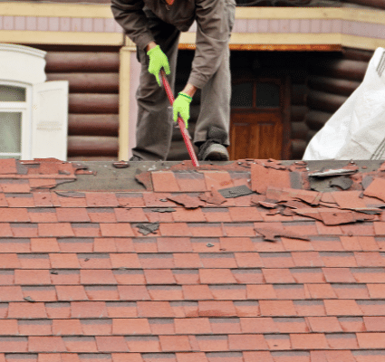 professionals repairing red roof