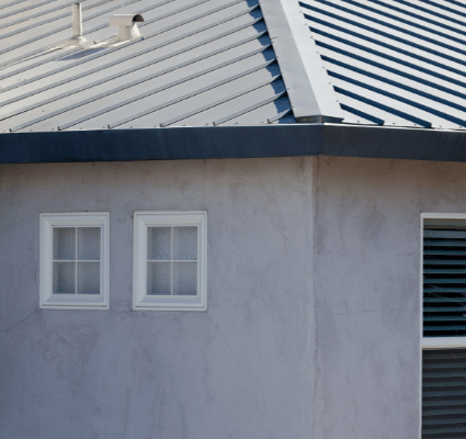 A house with a metal roof and two windows