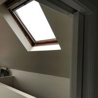 There is a skylight in the ceiling of the room.