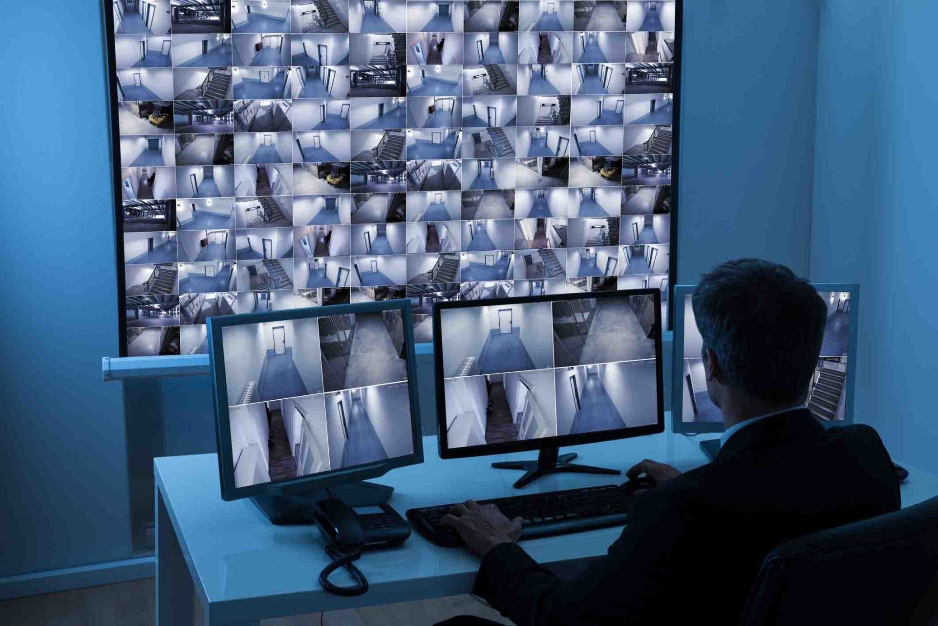 Man In Control Room Monitoring CCTV Footage — West Monroe, LA — DSC Security & Communications LLC