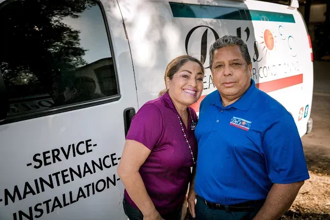 Couple stands next to a white van with 