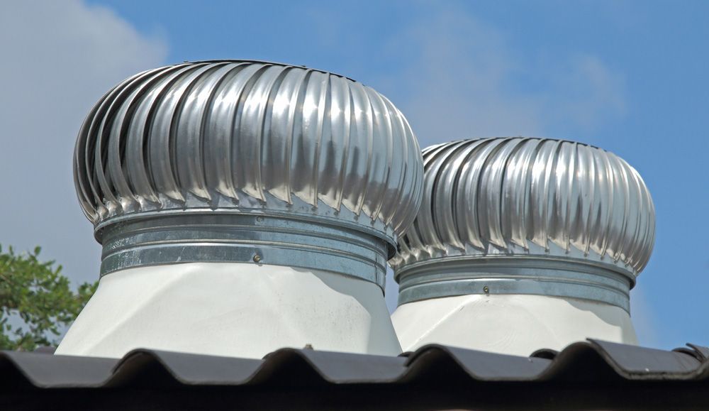 Two Whirlybird on a Grey Metal Roofing — SRV Roofing in Gympie, QLD
