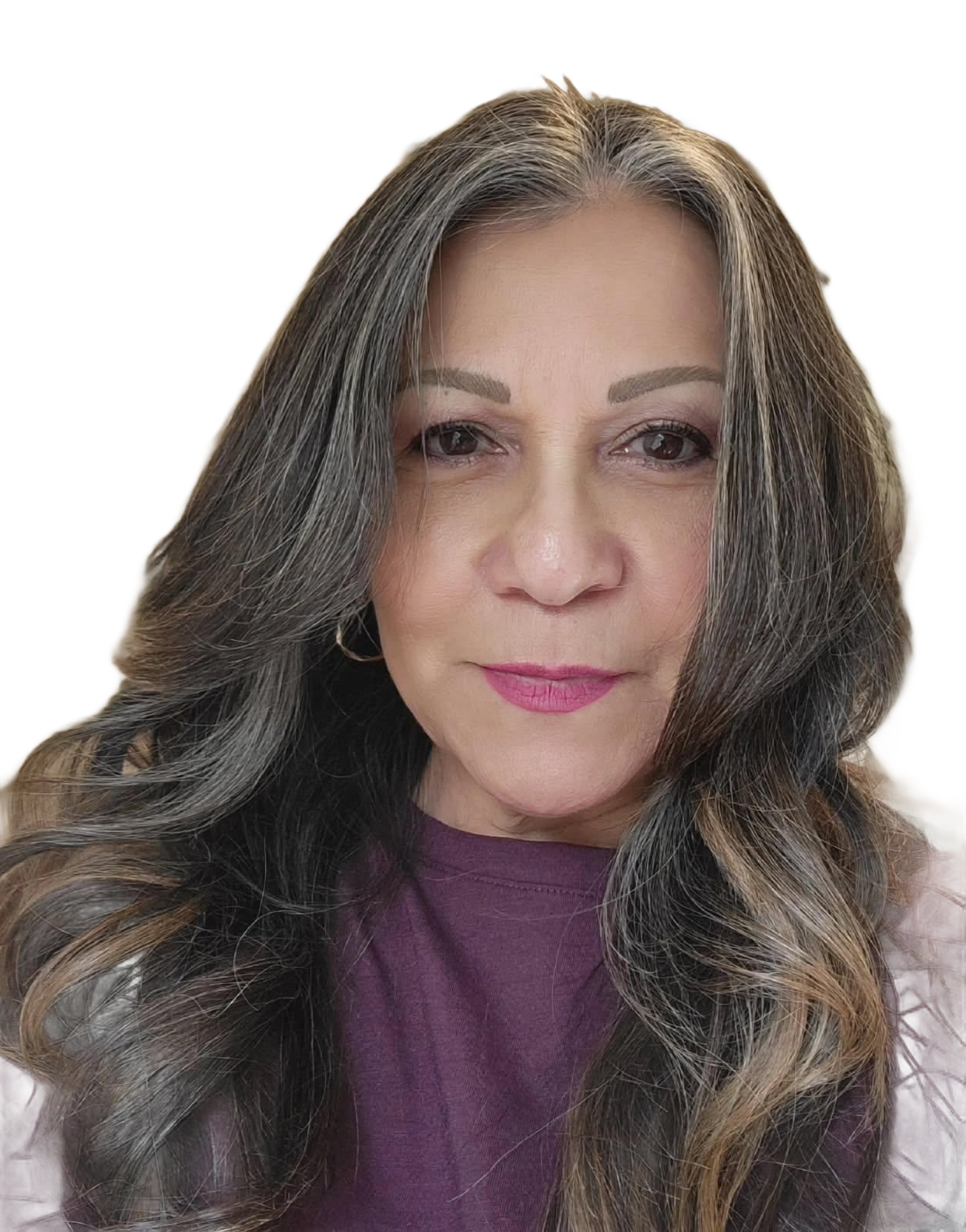 Woman with long, wavy brown hair, wearing a purple top, looking at the camera.