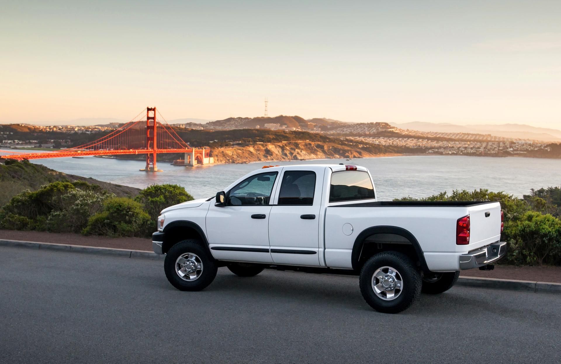White pickup truck parked overlooking the Golden Gate Bridge at sunset
