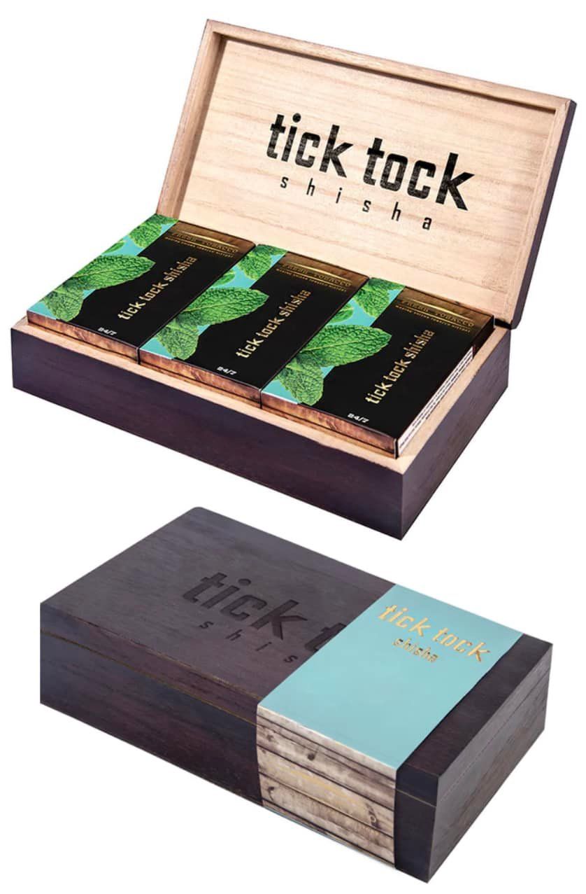 Wooden box containing three tea bars. The box is opened and closed with a turquoise label that reads “tick tock”.