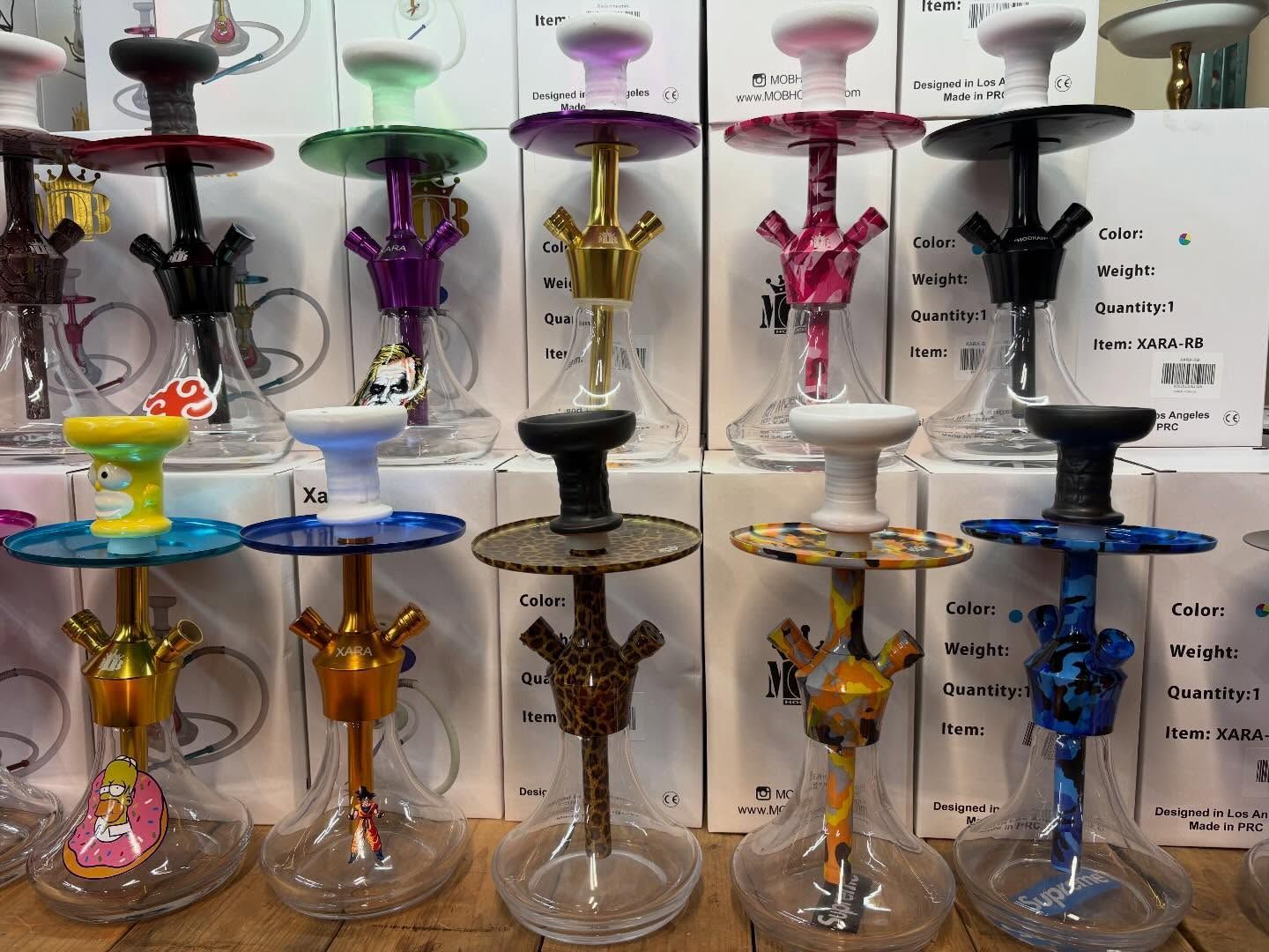 Rows of colorful hookahs on display, various colors and designs.