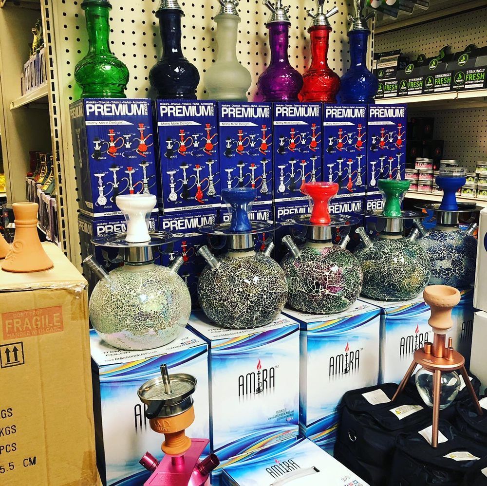 A store display featuring colorful hookahs, boxes, and accessories.