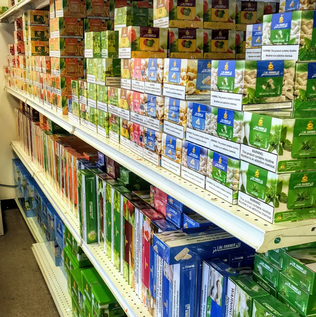 Shelves stocked with various boxes of tobacco products.