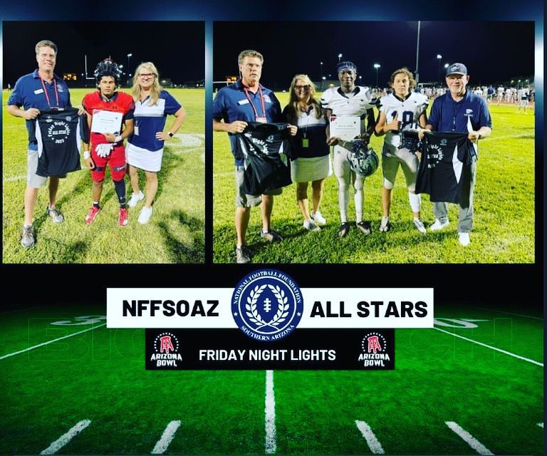 Two groups of football players and coaches on a field holding awards. 