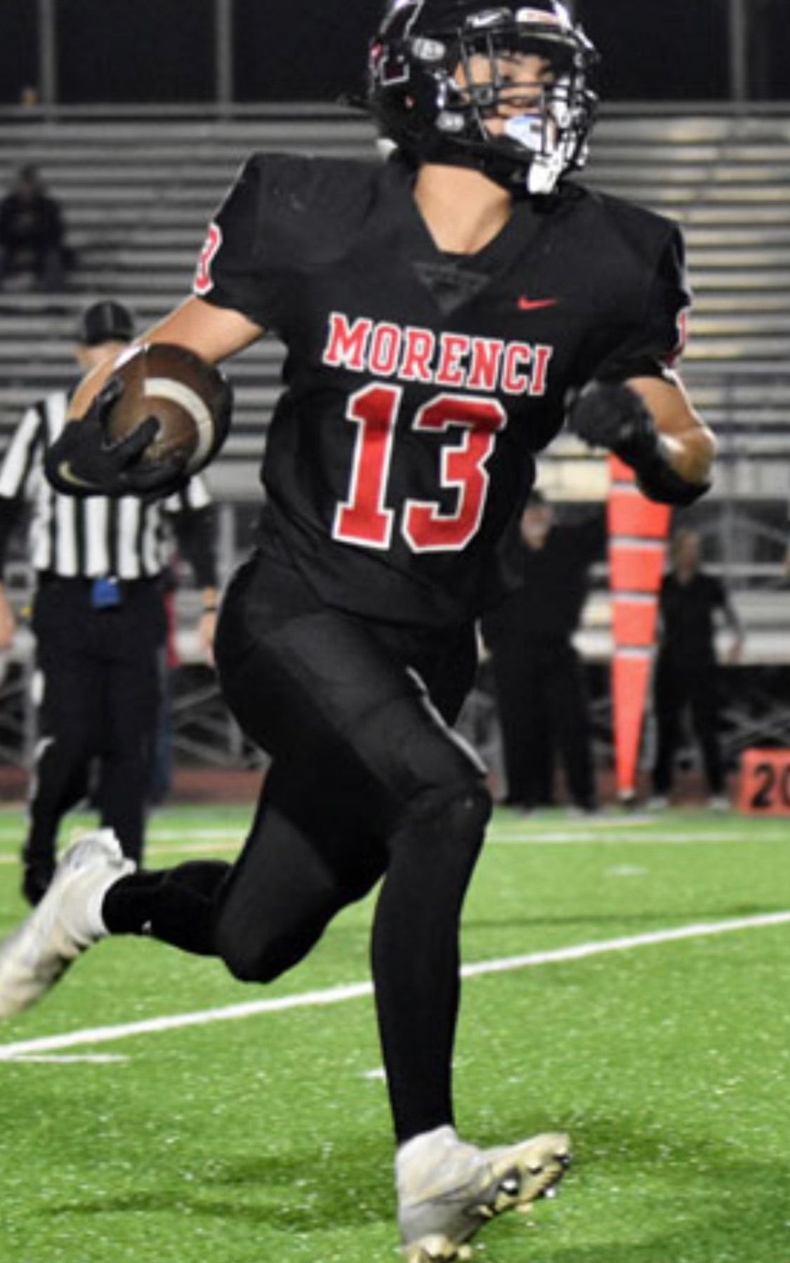 Football player in black uniform with 