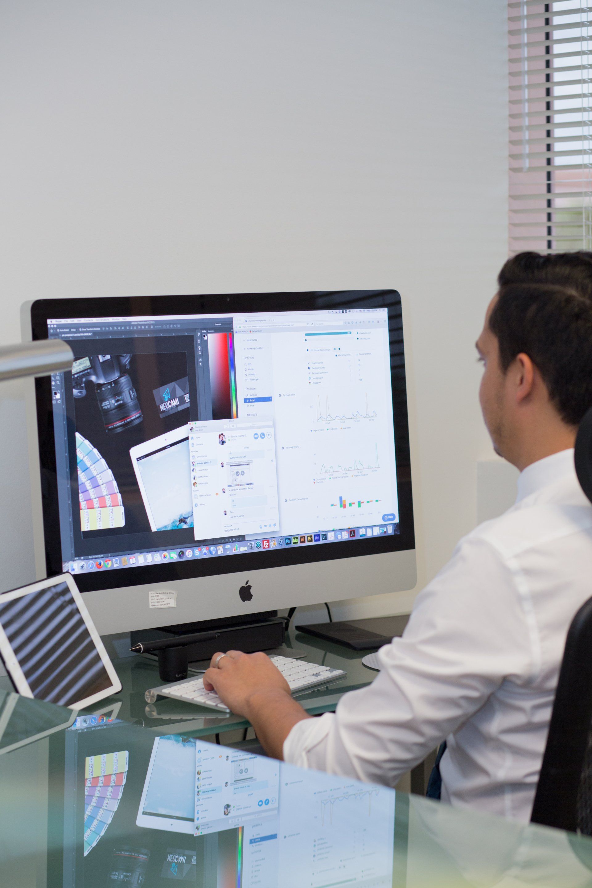 a man is sitting at a desk working on a computer .
