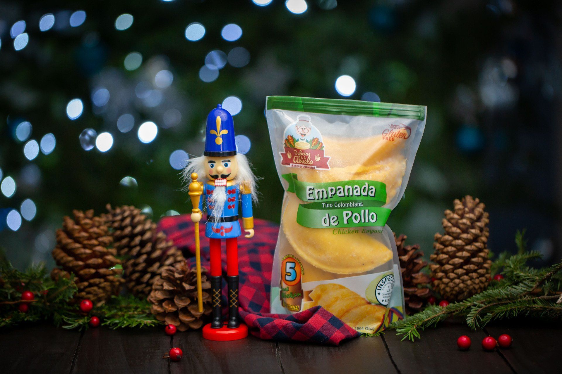 A nutcracker is standing next to a bag of empanadas.