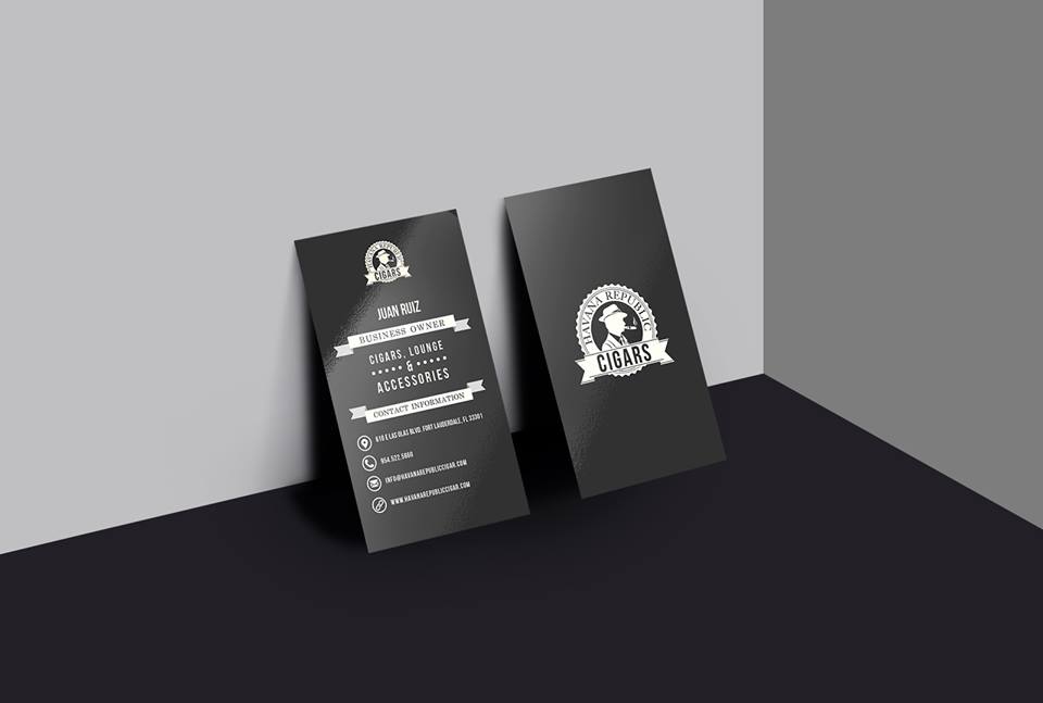 two black business cards are sitting on a black table .