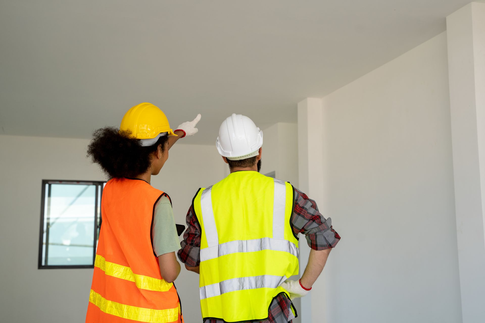 A man and a woman are standing next to each other in a room.