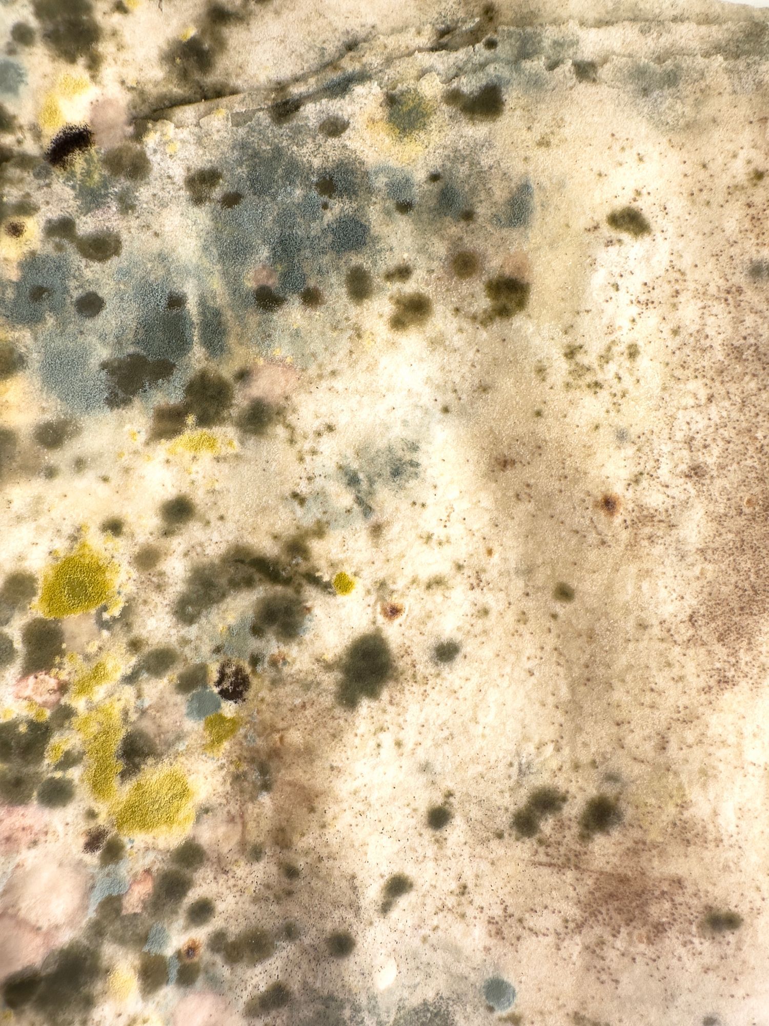 A man is laying on a white sheet in a basement.