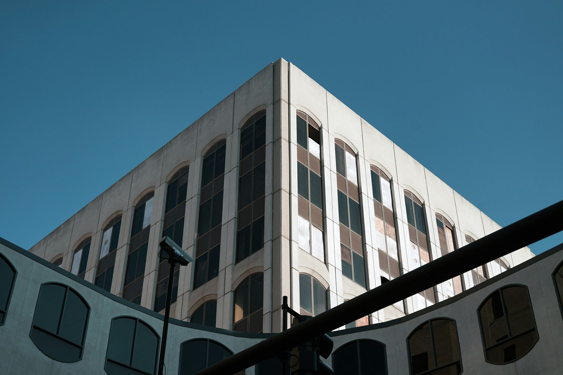Looking up at a tall building with a blue sky in the background