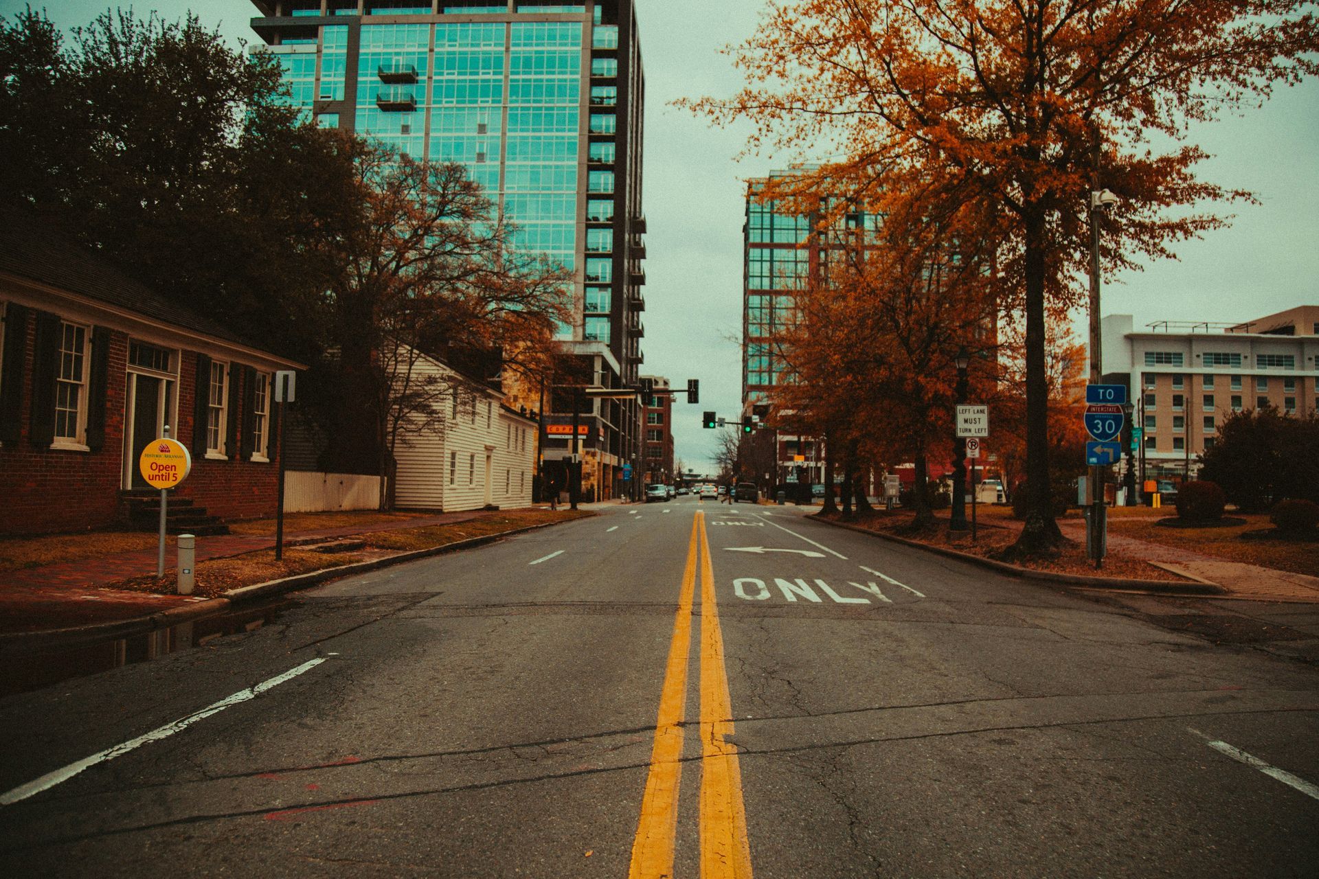 An empty city street with a sign that says only on it