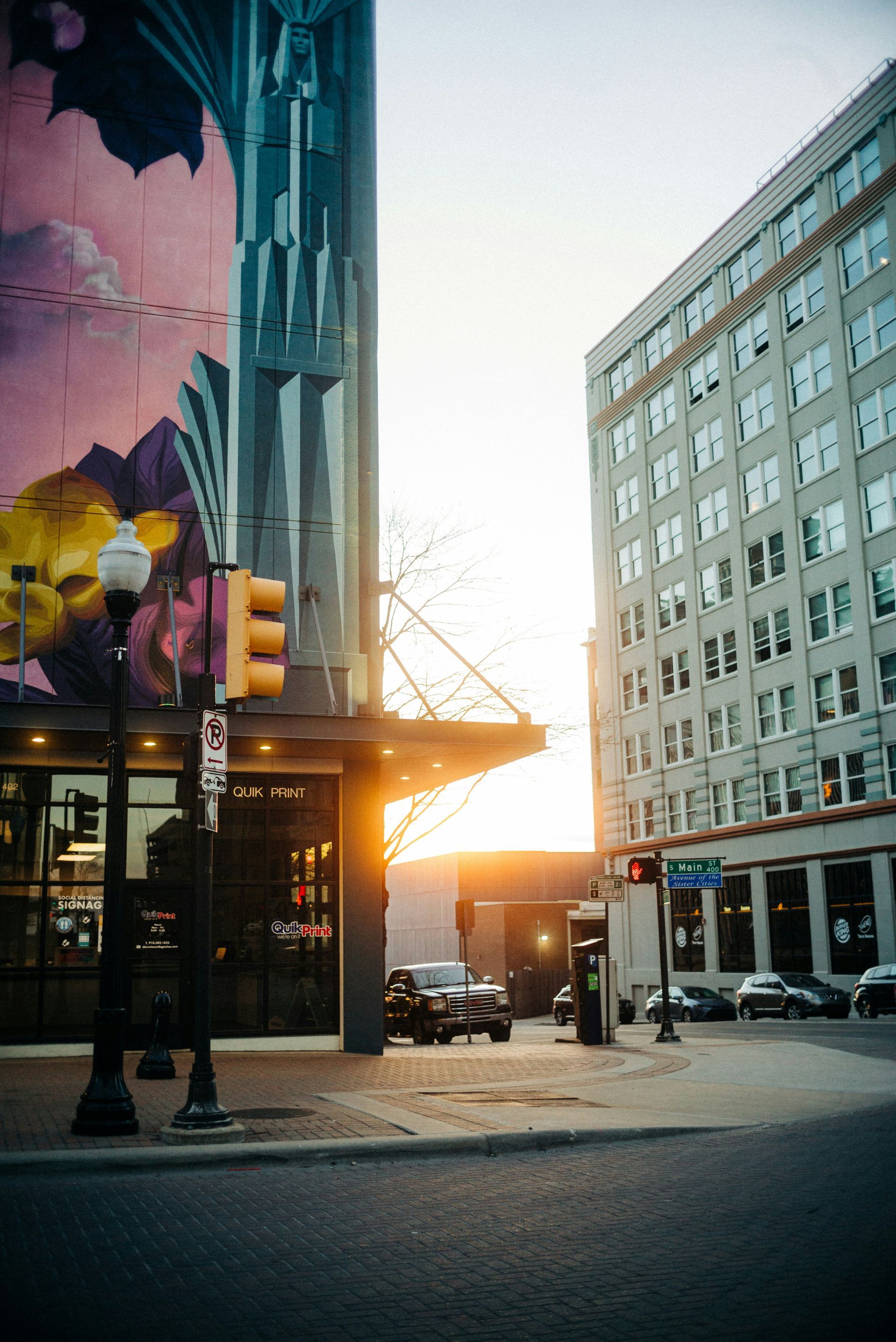 A city street with a mural on the side of a building