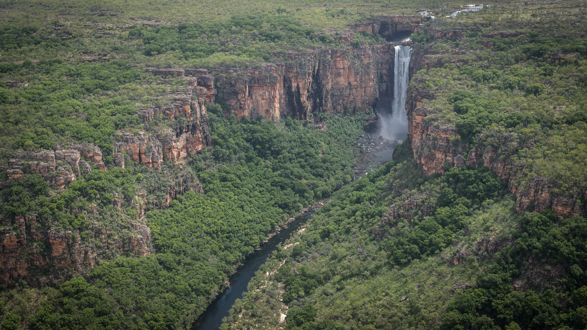 Waterfall Cascading Down a Rocky Cliff Into a River — Kakadu Billabong Safari Camp In Kakadu, NT