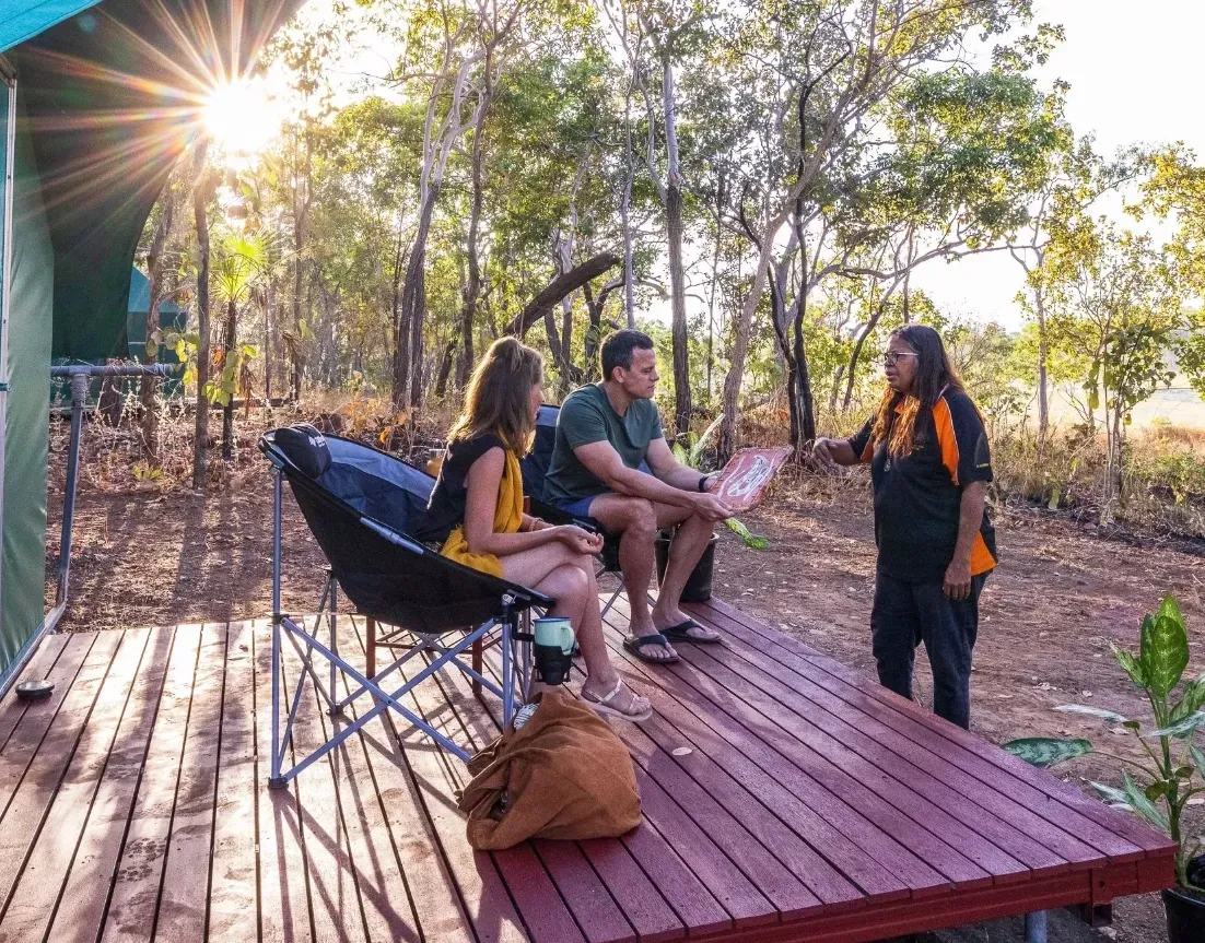 A Couple With Tour Guide Looking At A Traditional Bark Painting — Kakadu Billabong Safari Camp in Kakadu, NT