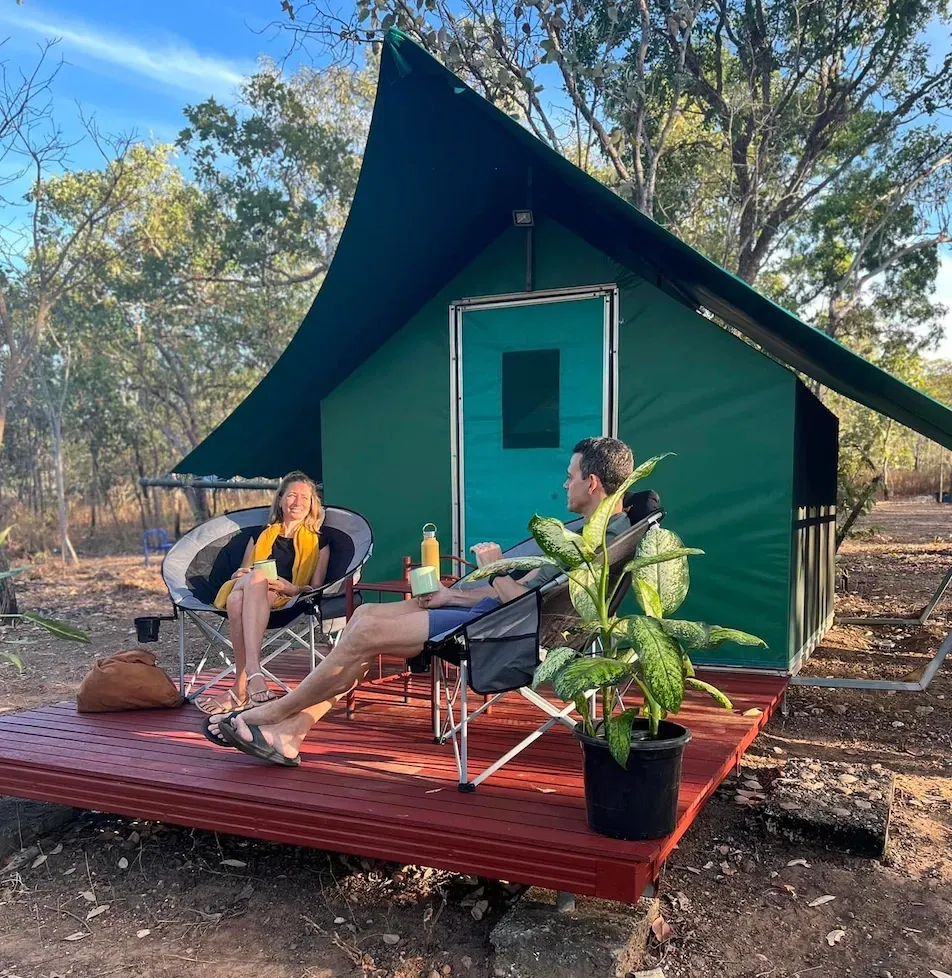 A Couple Sitting on the Deck of A Cabin at The Kakadu Safari Campsite — Kakadu Billabong Safari Camp in Kakadu, NT